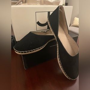 Black suede espadrilles with detailed stitching.